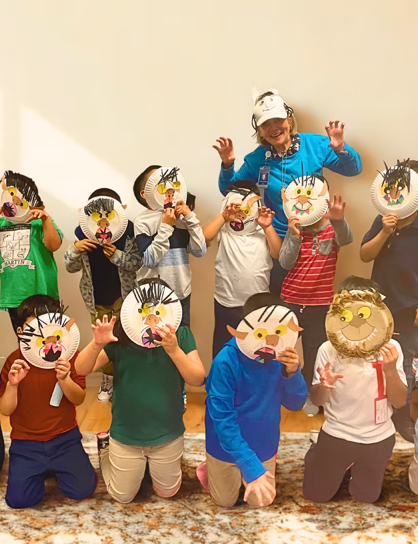 Children with painted paper plate masks