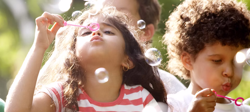 ibis-learning-children-blowing-bubbles image Children blowing bubbles outdoors