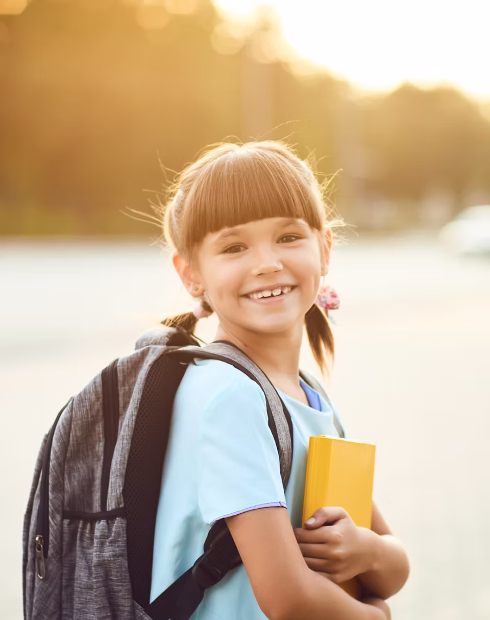 ibis-learning-curriculum-and-learning image Smiling girl with backpack holding a book